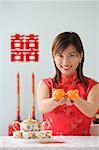 Young woman performing tea ceremony and smiling at camera