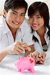 Young couple with piggy bank