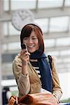 Young woman with mobile phone at the airport