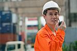 Construction worker talking on walkie talkie