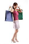 Woman standing, carrying shopping bags