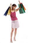 Woman standing, raising shopping bags