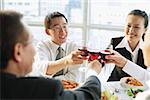 Executives at restaurant, toasting with wine