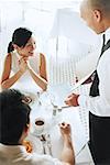 Waiter showing menu to couple at restaurant