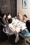 Group of friends having dinner at restaurant