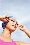 Femme réglage natation lunettes, regarder loin