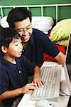 Father and son using computer