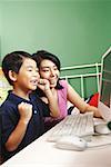 Mother and son looking at computer, smiling