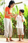 Mother and son standing, looking at terrapin