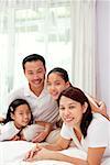 Family of four in smiling at camera