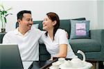 Couple in living room, laughing