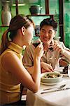 Couple dining in Chinese restaurant, drinking wine