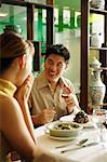 Couple in restaurant, man proposing with ring