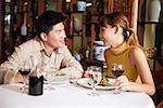 Couple dining in restaurant, sitting face to face