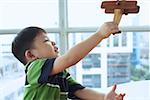 Young boy playing with toy airplane