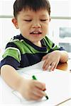 Young boy with crayon, drawing