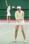 Women playing a game of mixed doubles tennis