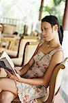 Woman sitting, reading a book