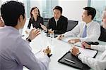 Executives having a discussion around conference table