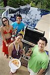 Couples at barbeque party, smiling at camera, portrait