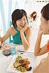 Young women talking over lunch in cafe
