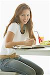 One woman sitting at table, smiling at camera