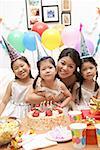 Mother with three girls celebrating a birthday