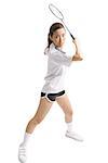 Young woman holding badminton racket, waiting to swing