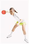 Young woman playing table tennis, studio shot