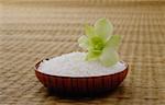 Bowl of rice with a flower, on a tatami mat