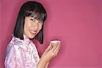 Woman holding Chinese tea cup