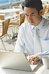 Businessman in cafe with laptop