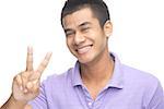 Man smiling at camera, making peace hand sign