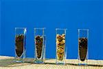 Tea leaves in glass containers, in a row