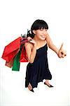Young woman carrying shopping bags, pointing finger