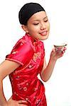 Young woman in cheongsam holding Chinese teacup