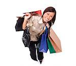 Woman carrying shopping bags, smiling up at camera
