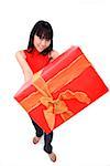 Young woman holding big red gift box towards camera