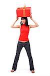 Young woman balancing big red gift box on her head