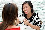 Two women at sidewalk cafe having lunch