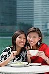 Two women having lunch, smiling at camera