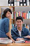 Couple in library, looking at camera