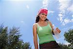 Young woman with bandana smiling at camera