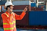 Man in work uniform talking on mobile phone