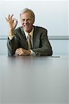 Businessman making OK hand gesture and smiling at camera