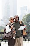 Couple in City with Map, New York City, New York, USA