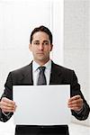 Businessman Holding Blank Piece of Paper