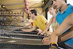 Teenagers playing game in amusement park