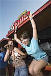 Two female teenagers hanging out, eating pizza