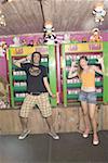 Teenage couple posing at game in amusement park